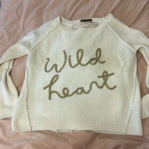 soft white sweater, with gold writing on the front (wild heart) 💕